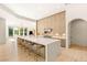 Spacious kitchen featuring a large island, bar stool seating, and streamlined wood cabinetry for a modern aesthetic at 8895 S Tenaya Way, Las Vegas, NV 89113