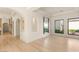 Light wood floors and white walls create a spacious, airy feel throughout the open-concept living room at 8895 S Tenaya Way, Las Vegas, NV 89113