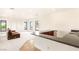 Open-concept living room with wet bar and large windows at 8895 S Tenaya Way, Las Vegas, NV 89113