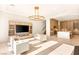 Spacious living area with a media center, stairs, and open concept to the kitchen at 8895 S Tenaya Way, Las Vegas, NV 89113