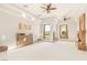 Bright main bedroom boasts ceiling fans, tray ceilings, and a fireplace with views to the manicured outdoors at 8895 S Tenaya Way, Las Vegas, NV 89113