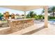 Outdoor kitchen featuring stone countertops, columns, built-in grill, and access to playground at 8895 S Tenaya Way, Las Vegas, NV 89113
