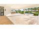 Spacious travertine patio with outdoor bar and a view of the lushly landscaped pool area at 8895 S Tenaya Way, Las Vegas, NV 89113