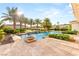 Inviting pool area surrounded by lush greenery, mature trees, and travertine decking at 8895 S Tenaya Way, Las Vegas, NV 89113