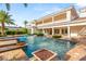 Resort-style pool and spa with lush landscaping and a spacious patio, perfect for relaxation and outdoor entertaining at 8895 S Tenaya Way, Las Vegas, NV 89113
