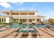 Luxurious pool and hot tub area with lush landscaping and ample room for recreation at 8895 S Tenaya Way, Las Vegas, NV 89113