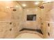 Large walk-in shower with dual shower heads, marble surround, and seating area at 8895 S Tenaya Way, Las Vegas, NV 89113