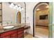 Large walk-in shower with marble surround, dual shower heads, and seating area at 8895 S Tenaya Way, Las Vegas, NV 89113