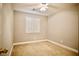 Neutral bedroom featuring carpeted floor, white trim, plantation shutters and a ceiling fan at 9144 Clear Sky Ave, Las Vegas, NV 89178