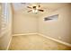 Carpeted bonus room featuring a ceiling fan, window with plantation shutters, and neutral color palette at 9144 Clear Sky Ave, Las Vegas, NV 89178
