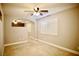 Carpeted bonus room featuring a ceiling fan, window with plantation shutters, and neutral color palette at 9144 Clear Sky Ave, Las Vegas, NV 89178