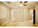 Carpeted bonus room featuring a ceiling fan, window with plantation shutters, and neutral color palette at 9144 Clear Sky Ave, Las Vegas, NV 89178