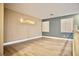 Hallway with hardwood floors, light walls and blue accent wall with two windows at 9144 Clear Sky Ave, Las Vegas, NV 89178