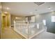 Hallway with white railing overlooking living space with hardwood floors at 9144 Clear Sky Ave, Las Vegas, NV 89178