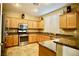 Bright kitchen with stainless steel appliances and granite countertops and light wood cabinets at 9144 Clear Sky Ave, Las Vegas, NV 89178