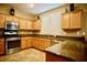 Kitchen featuring stainless steel appliances, granite countertops, and light wood cabinets at 9144 Clear Sky Ave, Las Vegas, NV 89178