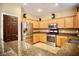 Kitchen with stainless steel appliances, granite countertops, and light wood cabinetry at 9144 Clear Sky Ave, Las Vegas, NV 89178