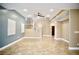Expansive living area showcasing tile floors, a staircase, and a view of an upper-level balcony at 9144 Clear Sky Ave, Las Vegas, NV 89178