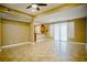 Large living area with tile flooring, light-colored walls, and a seamless transition to the kitchen and dining spaces at 9144 Clear Sky Ave, Las Vegas, NV 89178