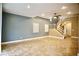 Open living room features neutral walls, tile floors, and staircase leading to upper level at 9144 Clear Sky Ave, Las Vegas, NV 89178