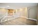 Upstairs living room with hardwood floors, white railing, and neutral paint at 9144 Clear Sky Ave, Las Vegas, NV 89178
