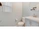 Well-lit powder room featuring a modern vanity and a round mirror at 928 Shades End Ave, North Las Vegas, NV 89081