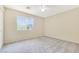A well-lit bedroom featuring neutral walls, plush carpeting, and a window that offers natural light at 928 Shades End Ave, North Las Vegas, NV 89081