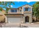 Charming two-story home with a two-car garage, desert landscaping, and blue window shutters at 928 Shades End Ave, North Las Vegas, NV 89081
