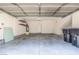 A functional two-car garage with ample storage space, equipped with shelving, and a concrete floor at 928 Shades End Ave, North Las Vegas, NV 89081