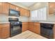 Kitchen with wood cabinets, stainless sink, gas stove, microwave and dishwasher at 928 Shades End Ave, North Las Vegas, NV 89081
