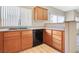 Kitchen boasts wood cabinets, a stainless sink, and a black dishwasher at 928 Shades End Ave, North Las Vegas, NV 89081