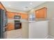 Bright kitchen features modern appliances, wooden cabinets, and a breakfast bar for casual dining at 928 Shades End Ave, North Las Vegas, NV 89081