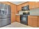 Kitchen features stainless steel refrigerator, a microwave, and a gas stove and oven at 928 Shades End Ave, North Las Vegas, NV 89081