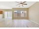 Spacious living room with wood-look flooring, ceiling fan, and sliding glass door at 928 Shades End Ave, North Las Vegas, NV 89081