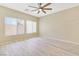 Bright living room with wood-look floors, lots of natural light, and a ceiling fan at 928 Shades End Ave, North Las Vegas, NV 89081