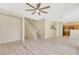 Open-concept living room showcasing the staircase, access to the kitchen, and wood-look floors at 928 Shades End Ave, North Las Vegas, NV 89081