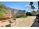 Outdoor patio with chairs and lush green space with palm trees at 931 Highland Trails Ave, Henderson, NV 89015