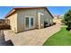 Backyard with a brick patio, green grass, and outdoor seating with a grill at 931 Highland Trails Ave, Henderson, NV 89015