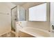 Bathtub and shower with glass door and ducky tiles at 931 Highland Trails Ave, Henderson, NV 89015