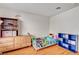 Cozy bedroom with a dresser, toys and hardwood floor at 931 Highland Trails Ave, Henderson, NV 89015