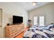Cozy bedroom with a dresser, TV, wood floors, and access to the outdoors at 931 Highland Trails Ave, Henderson, NV 89015