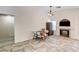 Cozy dining area featuring a fireplace, tile floors, and natural lighting from a window at 931 Highland Trails Ave, Henderson, NV 89015