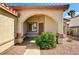 Inviting front entrance with an arched entryway and desert landscaping at 931 Highland Trails Ave, Henderson, NV 89015