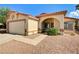 Inviting single-story home with a two-car garage and desert-style front yard at 931 Highland Trails Ave, Henderson, NV 89015