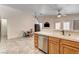 Cozy kitchen with tile flooring, wood cabinets, and stainless steel appliances at 931 Highland Trails Ave, Henderson, NV 89015