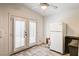 Bright kitchen area with tile floors, a ceiling fan, and natural light from the doors at 931 Highland Trails Ave, Henderson, NV 89015