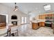 Bright kitchen with tile flooring, stainless steel appliances, wood cabinets, and a breakfast bar at 931 Highland Trails Ave, Henderson, NV 89015