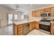 Kitchen featuring stainless steel appliances, light wood cabinets, and plenty of counter space at 931 Highland Trails Ave, Henderson, NV 89015