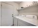 Laundry room featuring a white washer and dryer, a shelf, and white door at 931 Highland Trails Ave, Henderson, NV 89015