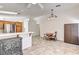 Open-concept living space with tile flooring, dining area, and kitchen with stainless steel refrigerator at 931 Highland Trails Ave, Henderson, NV 89015